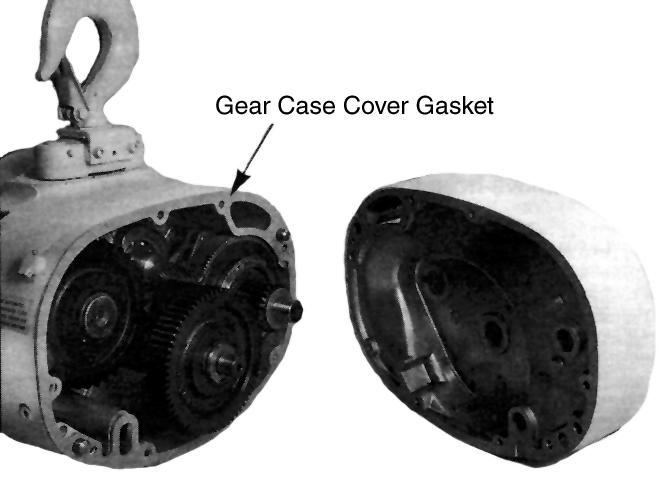 Pry gearcase cover off hoist frame using screwdriver at special notches provided at opposite corners of cover