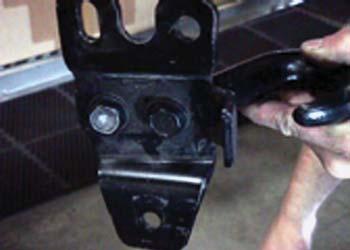 Position the driver side backing plate weldment through these holes on each side over the