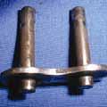 High chain tension causes pins or bushings to deform. Contact Engineering to run chain tension calculations.