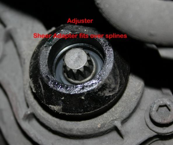 FIGURE 15 Adjuster Components Adjuster screw cap Shear adapter Adjuster with seal visible Make sure the bus has at least 95 psi air pressure and, if applicable, make sure the spring brake is released.