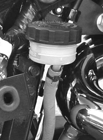 Rear Brake Fluid Level 1. Remove the right side cover. 2. Straddle the motorcycle and bring it to the fully upright position. 3. View the brake fluid through the reservoir. The fluid should be clear.