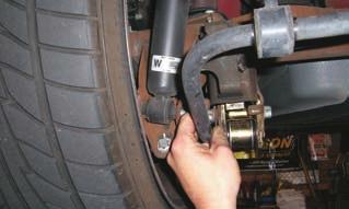 Pull back the carpet/trunk liner to access the top nut on the rear shock.