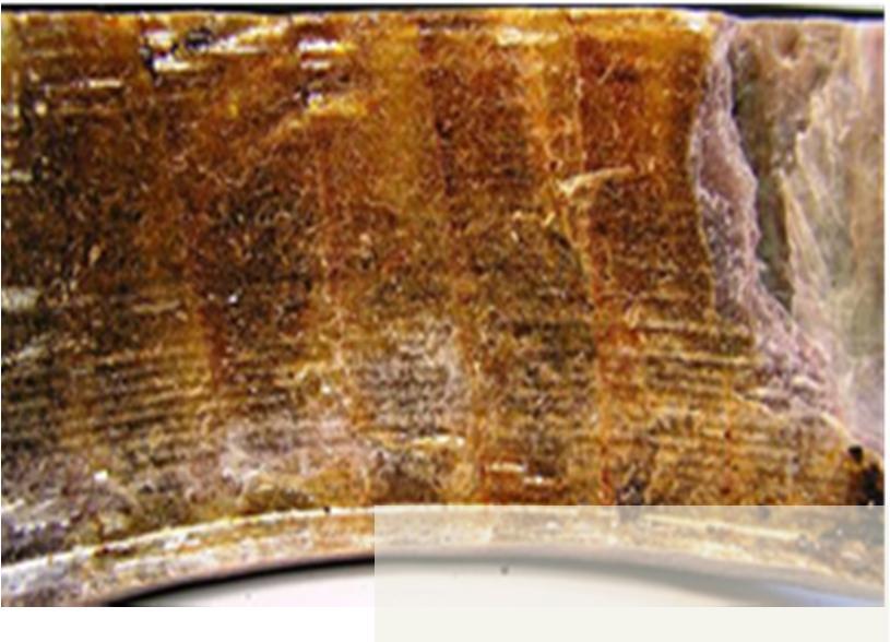 Copper conductor Thermal aging of epoxy-mica-insulation (dark brown color of resin) and delamination of insulation sleeve from copper conductor bundle Fig.