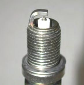 Note different tightening torques for new or previously installed spark plugs.