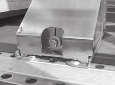 Always position the load securing wedge in the perforated rail with both flanged pins. The load securing wedges prevent the load from rolling and sliding across or along the trailer.