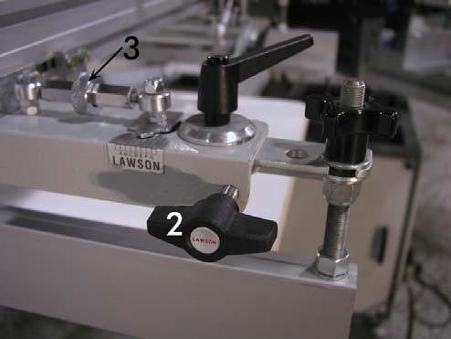 The zero target tab indicates the ideal starting location. To adjust the micro registration: 1) Loosen the two black ratchet knobs at the top-front of the print head (#1).