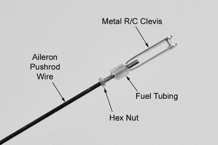 c) Insert the bent end of the pushrod into the servo arm, from the top. Note: You will most likely need to use a 1/16 dia.