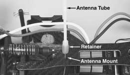Locate the antenna tube and retainer. Thread the receiver antenna through the retainer and then through the antenna tube.