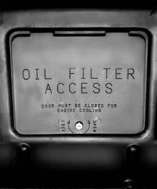Remote Oil Filter (Four-Wheel Drive) The access door for the remote oil filter is in the steering linkage shield assembly located under the radiator support. Turn the screw to unlock or lock the door.