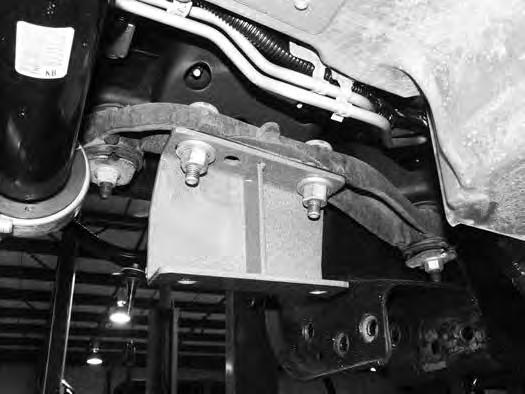 Using an appropriate jack, install the differential in the vehicle by attaching it to the new driver s and passenger s differential brackets.