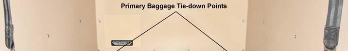The primary baggage compartment tie-down points are the D-rings located in