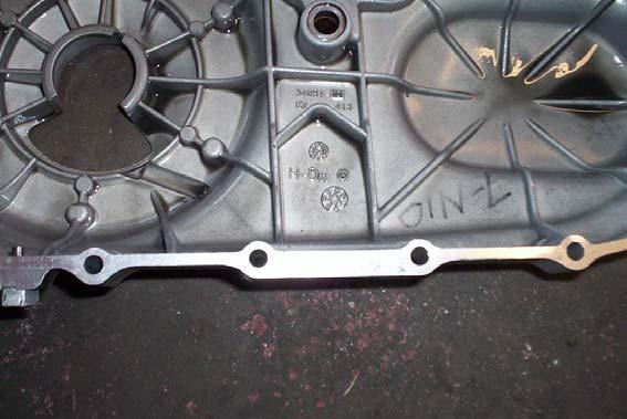 Step 6. Turn the adjustment bolt in clockwise and completely remove the stock tensioner from the primary cover. Step 7.