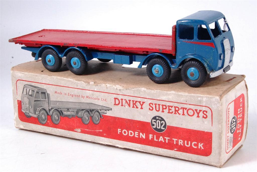 truck, 1st type cab with flash, dark blue cab, wings and chassis, red flash, mid blue hubs and red back, hook apparent, with spare tyre, model has paint chips, with metal fatigue apparent to flat
