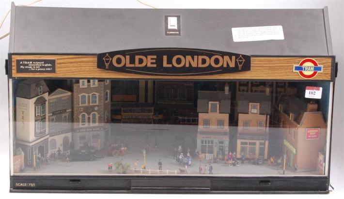 101 Cased diorama (plastic case) 1:75 scale 'A Street of Yesterdays 1890-1970', trains and buses, 28½ x 10 x 11 inches, provision for electric main lighting 40-50 102 Cased diorama (plastic case),