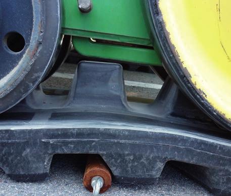 When turning, wheels tend to ride over the guide lugs and cause the chunking of guide lug When
