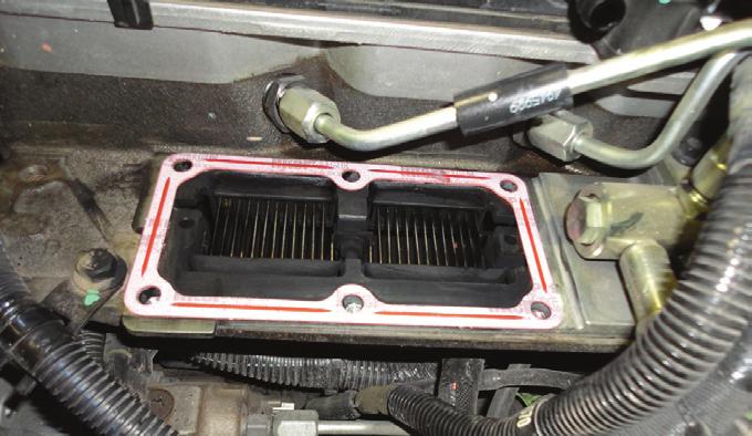 Apply a small amount of grease to top side of gasket (helps prevent gasket from breaking if intake manifold