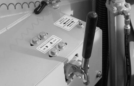 The winch control lever is the third lever on the hydraulic control lever panel. There is a decal next to the lever to show proper operation of the winch control.
