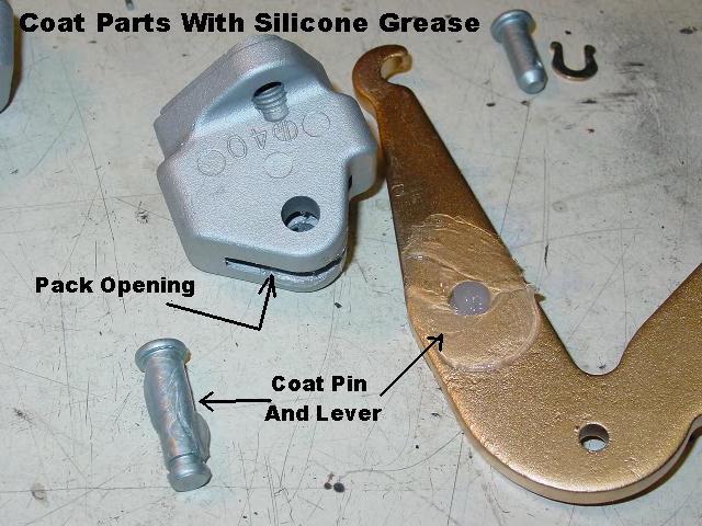 Liberally coat the pivot area of the bellcrank lever, and the pivot pin with silicone grease.
