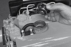 This has to be checked when the engine is cold. Remove the cap of the filler neck on the heat exchanger.