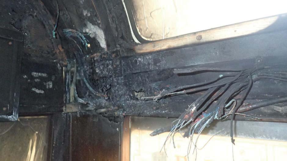 Fire damaged cabling within 272; the previous cable repair is indicated by the arrow As is common with older tramcars, car 272 was built of non-conductive materials comprising wooden and fibreglass