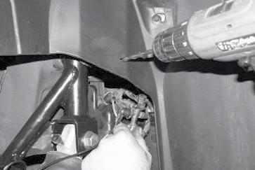 17. Remove the air line manifold from its connection point in the rear