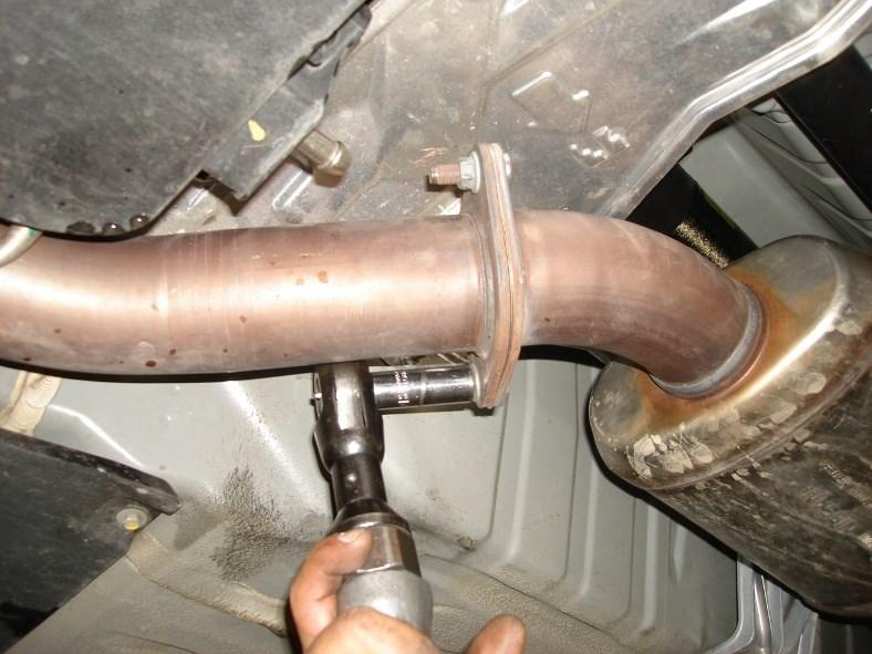 Loosen and remove flange bolts behind front muffler. Keep hardware for installation. (See Fig. 4) 4.