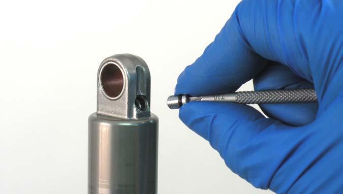 Use a small hex wrench or pick to depress the Schrader valve and release all air pressure from the IFP reservoir.