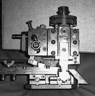 front of the press), and counter-clockwise to decrease the bell-mouth (move the guide rails towards the back of the press).