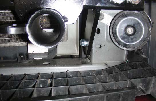 The lower mounting point should be lined up with the pre-existing hole in the radiar support.