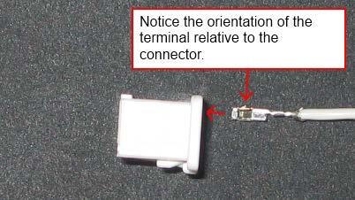 Before inserting the terminals into the connector, refer to the figure to be sure that the locking mechanism on the terminals is positioned properly in the connector.