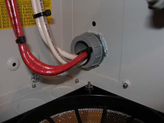 Wires pass through a 1 conduit knockout in the side plate. Install a 1 Close nipple, three 1 locknuts and two bushings to complete the wire passage.
