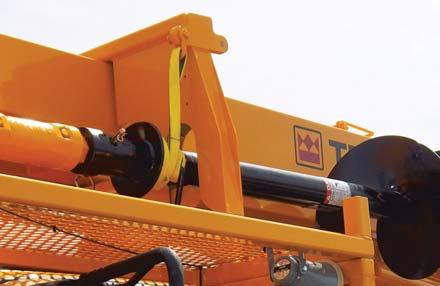 The auger sling, in swift wrap around action, lifts the auger to the boom where it is held securely in travel position.
