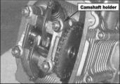 Turn the flywheel counterclockwise to make the "T" mark on the flywheel align with the mark on the crankcase.