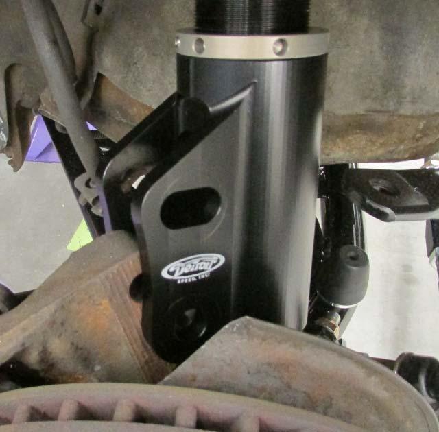 Figure 8 0 Camber Slug 12. Attach the spindle to the new strut using the M16 flange head bolts and nuts provided. Torque the M16 nuts to 150 ft./lbs. (Figure 9).