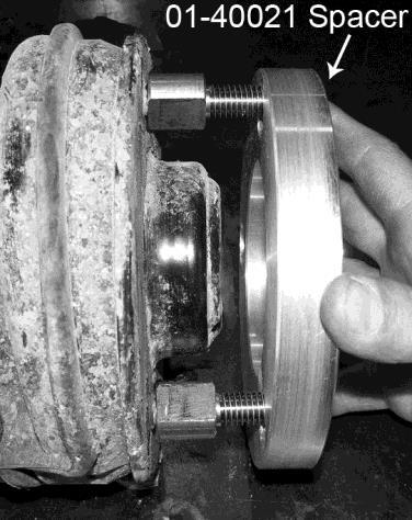 NOTE: When removing the strut, it is helpful to rotate the knuckle to gain clearance between the lower strut mount and axle shaft.