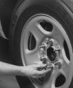 4. Remove all the wheel nuts and take off the flat tire. CAUTION: 5. Remove any rust or dirt from the wheel bolts, mounting surfaces and spare wheel.