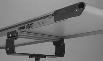 Attach clamp plates on each side of conveyor (Figure 11). Tighten the screws (AC) to 9 Nm.
