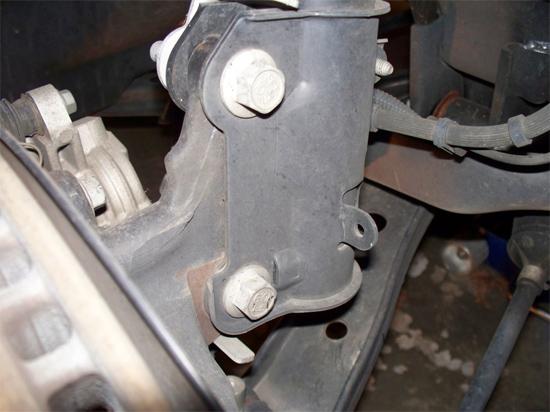 Now remove the two lower strut bolts and nuts from the spindle.