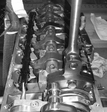 . 3.3.17. Using a new bolt secure the camshaft gear wheel and the tandem pump shaft, tighten bolt finger tight. At this point the camshaft gear wheel can still turn.