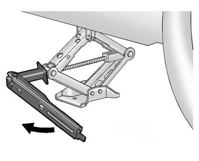 tire to fit under the vehicle. Keep the hook parallel to the ground. The wrench may need to be removed and repositioned to continue turning it.