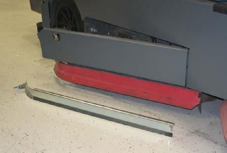 Tighten the front retaining band tension latch. 16. Reinstall the rear squeegee assembly onto the machine. 17.