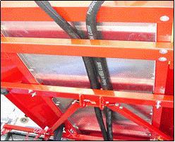 Figure 49: Routing Twin Spinner hoses 18. Lift the front of the ProPass up as high as possible using the lift cylinder.