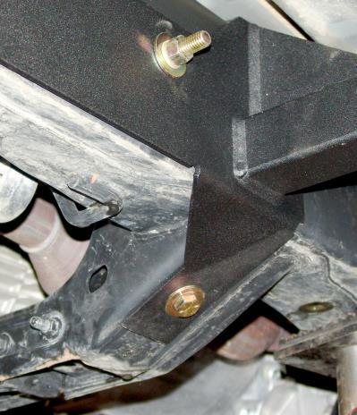 The bracket is located on the outside / forward side of the frame