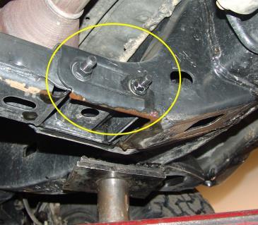 Remove bolts that secure transfer case to cross member.