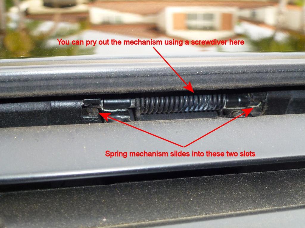 Step 6: In order to get the broken pieces out, you have to disconnect the wind deflector from its arms or remove it completely. Electronically slide the sunroof guides back about 8 inches.