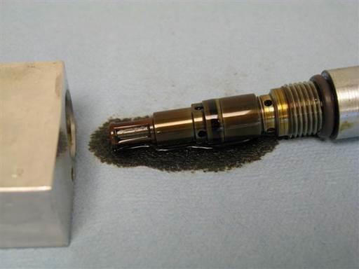 Unscrew oil pressure restrictor from valve body