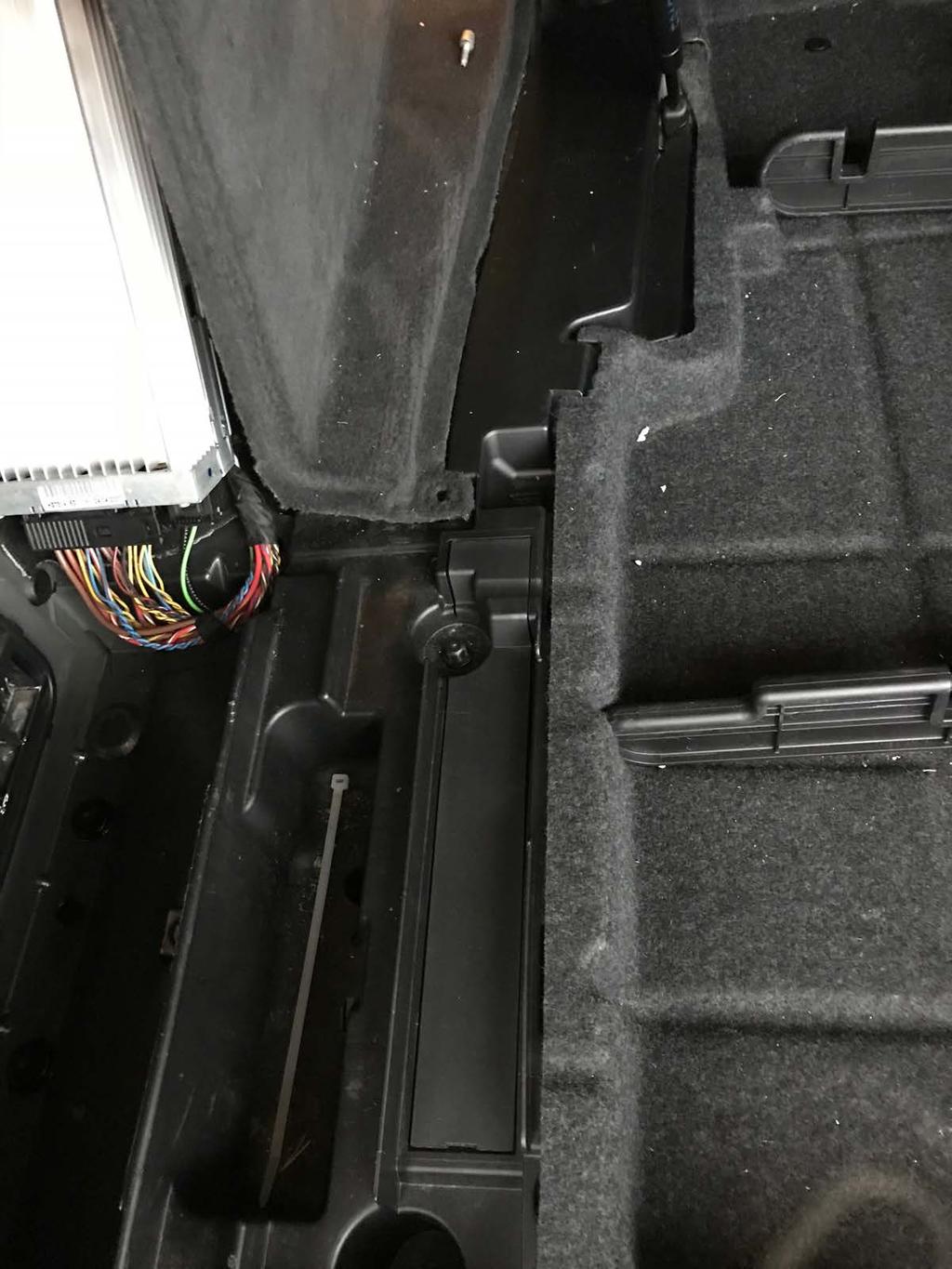 Open the floor lid and remove the plastic push-pin lock for the interior side panel.