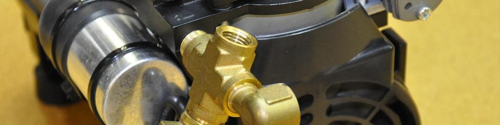 When tight, the brass elbow should be pointing toward the back side of the pump as shown below. 9. Use a 9/16" wrench to attach the vacuum gauge to the brass cross. 10.