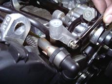 Remove the bolt that secures the power steering high-pressure line to the valve