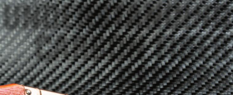 aluminum and traditional composite materials. Carbon fiber is made of thin carbon filaments bound together with a plastic polymer resin to form a composite material.